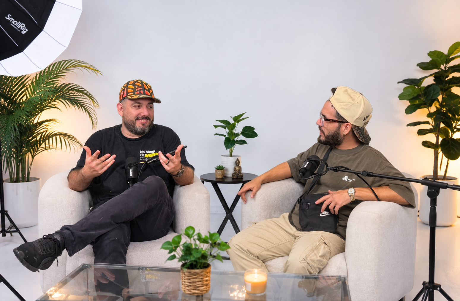 Two hosts recording a podcast in the studio lounge